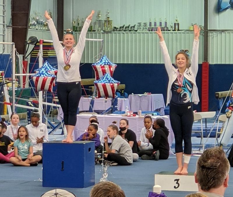 Zoe Tuttle, left, finished first on bars and beam and claimed the all-around title for her age group.